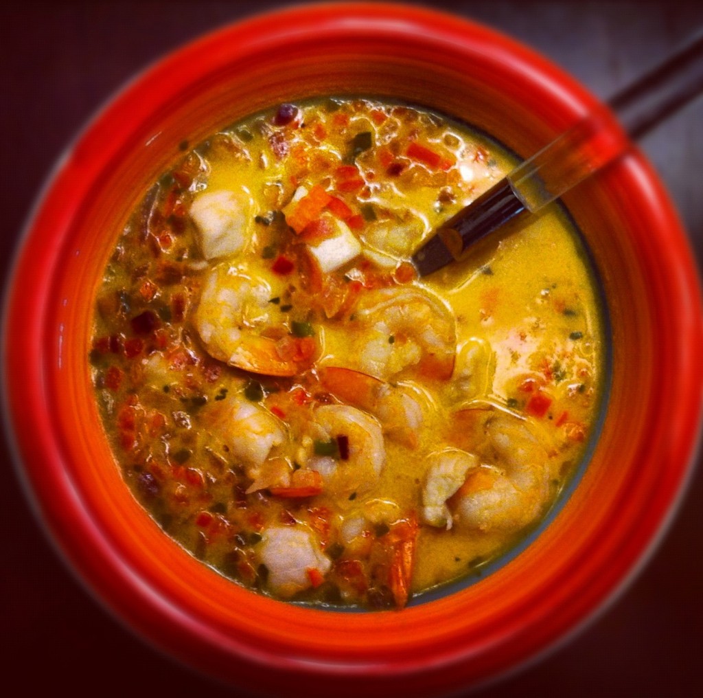 Bright red bowl filled with fish stew