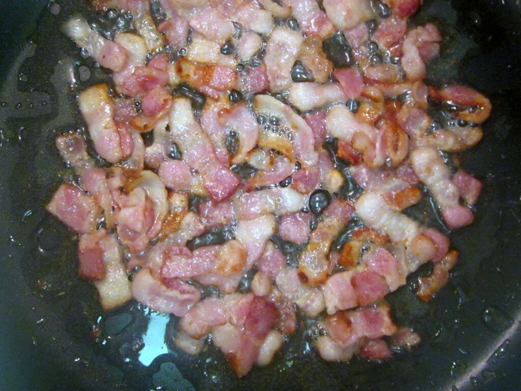 Bacon lardons bacon lardons sauteeing in a skillet